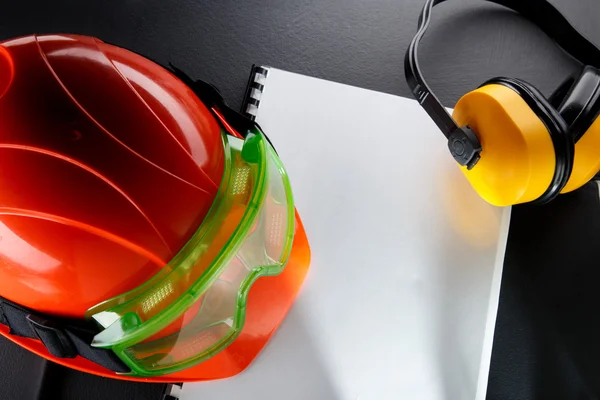 Goggles, earphones and red helmet — Stock Photo, Image