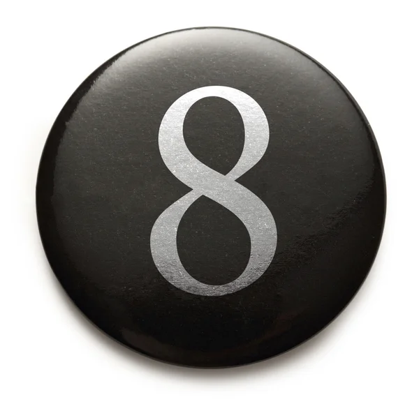 Numero bianco 8 sul distintivo nero — Foto Stock