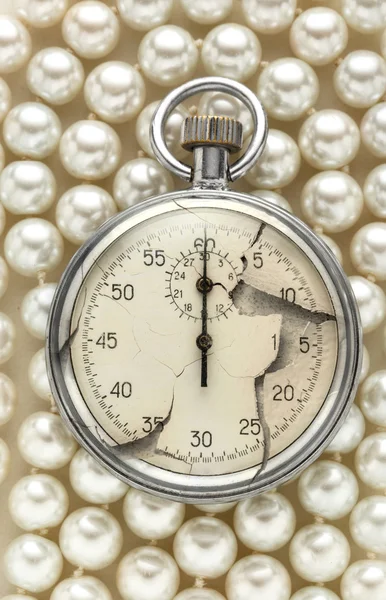 Cracked stopwatch on white pearl — Stock Photo, Image