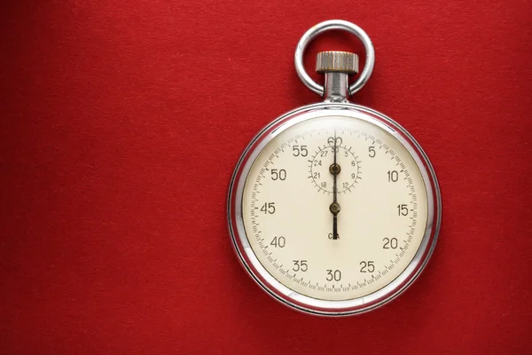 Stopwatch on red paper — Stock Photo, Image
