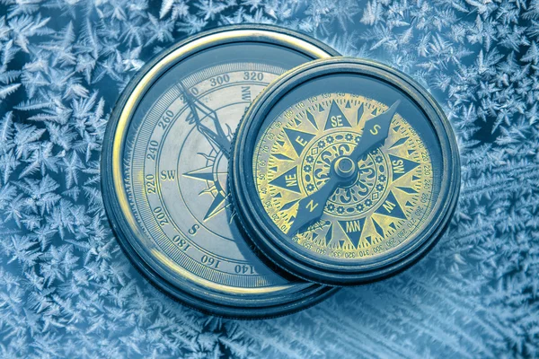 Vintage compasses on snowflakes — Stock Photo, Image