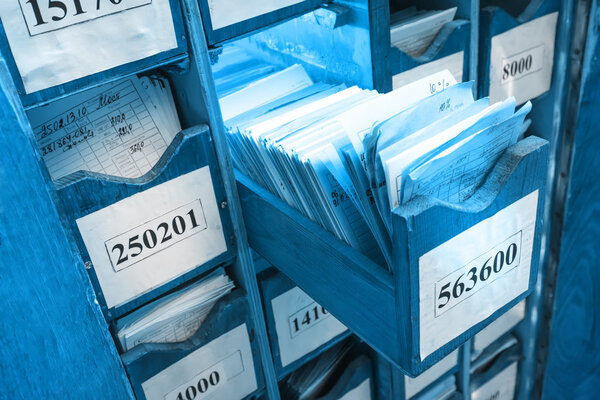 Paper documents stacked in archive