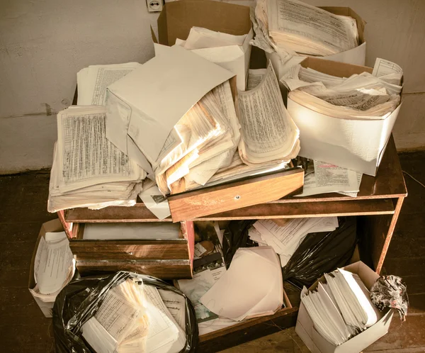 Table and stack of paper — Stock Photo, Image