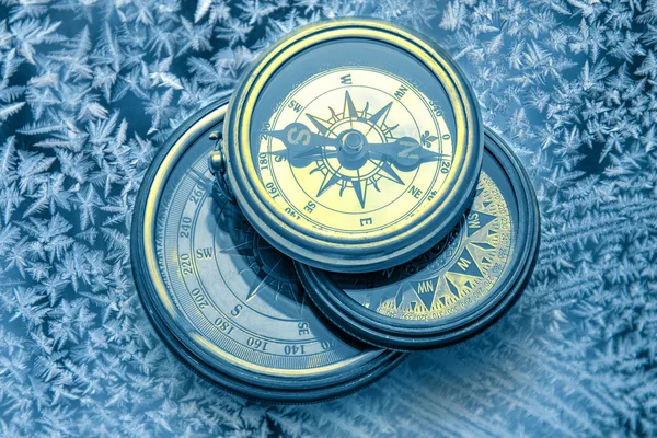 Vintage compasses on snowflakes — Stock Photo, Image