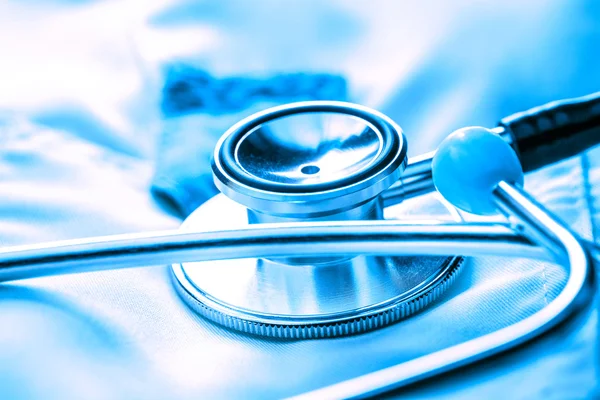 Stethoscope on white medical coat — Stock Photo, Image