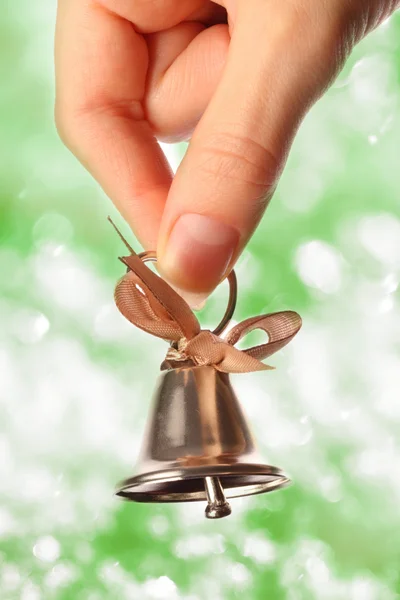 Bell in female hand closeup Royalty Free Stock Images