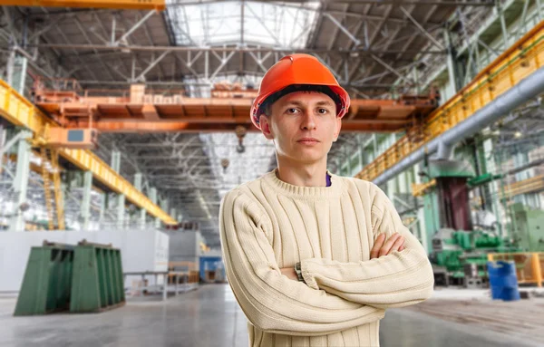 Workman in red helmet in the workshop — Stock Photo, Image