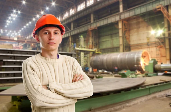 Workman in red helmet in the workshop — Stock Photo, Image