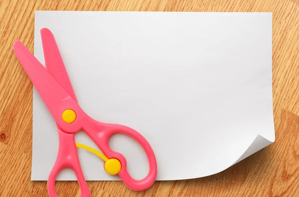 Safe scissors on blank white paper — Stock Photo, Image