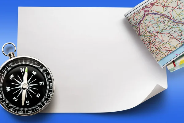 Compass with map on paper