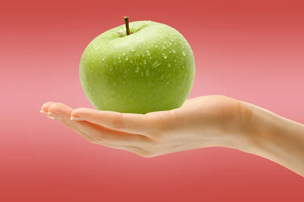 Female hand with green apple — Stock Photo, Image