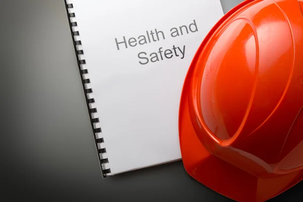 Health and safety register with helmet — Stock Photo, Image