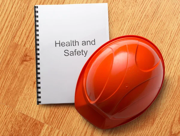 Health and safety register with helmet — Stock Photo, Image