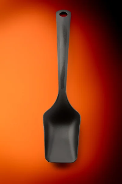 Black plastic kitchen spoon — Stock Photo, Image