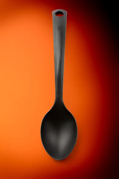 Black plastic kitchen spoon — Stock Photo, Image