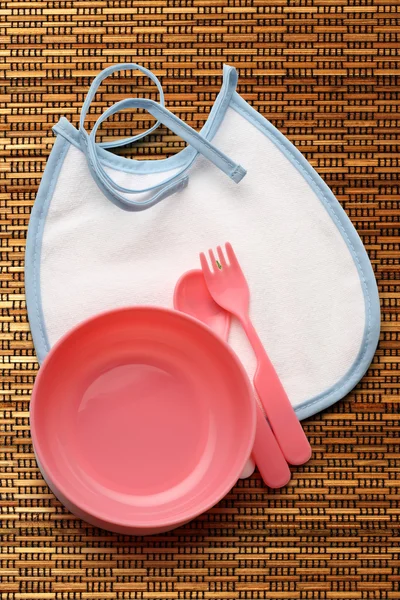 Bibs, bowl and spoon for baby — Stock Photo, Image