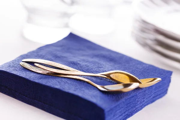 Napkins with spoons, plates and glasses — Stock Photo, Image