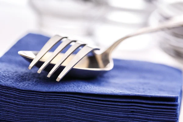 Paper napkins with spoon and fork — Stock Photo, Image