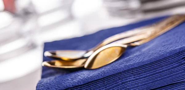 Dark blue paper napkins with spoons — Stock Photo, Image