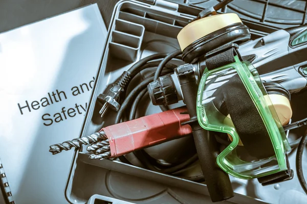 Perforator with earphones and goggles — Stock Photo, Image