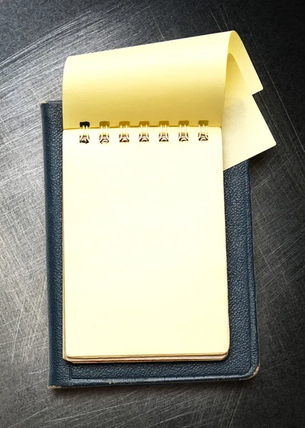 Yellow blank notepad with open page — Stock Photo, Image