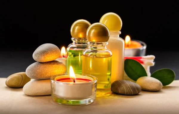 Spa stones, candle and shampoo bottles Stock Picture