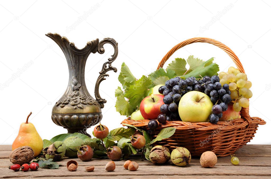 Metal jug and fruit on the table