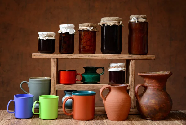 Various pottery and jam in jars of glass — Stock Photo, Image