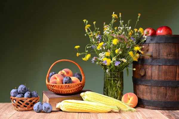 Flowers from the garden, fruit and wooden barrel — Stock Photo, Image