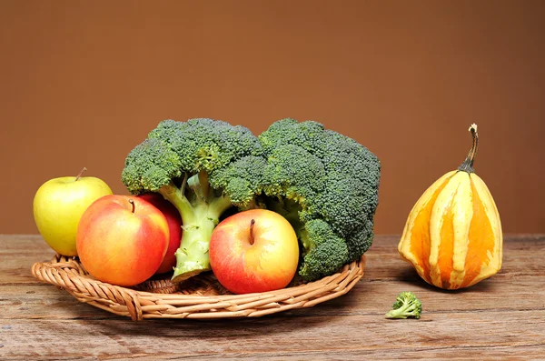 Broccoli, apples and decorative pumpkins — Stock Photo, Image