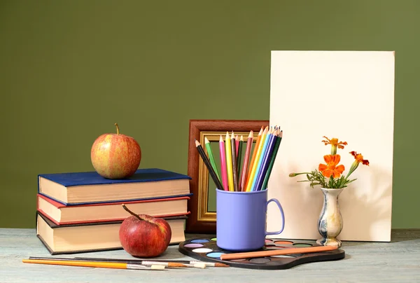 Books, apples, colored pencils and painting canvas — Stock Photo, Image