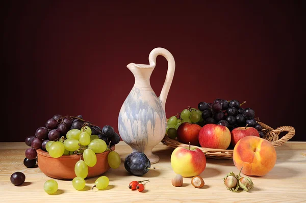 Various fruits and a ceramic jug — Stock Photo, Image