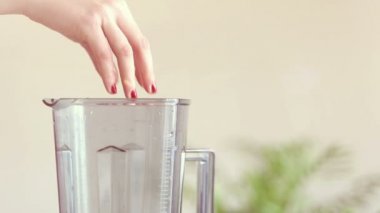 Karıştırıcıda meyve koyarak kadın