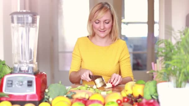 Woman cutting banana into slices — Stockvideo