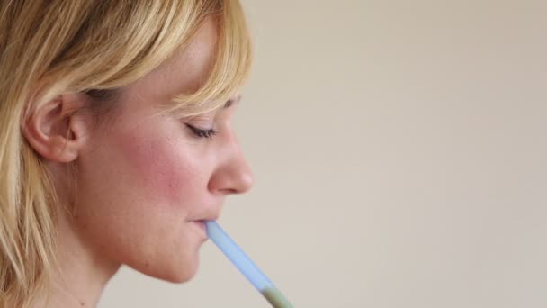 Woman drinking smoothie with a straw — Stok video
