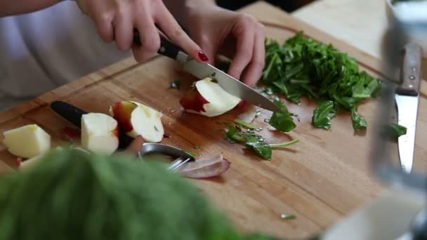 Woman cutting apple on pieces — Wideo stockowe