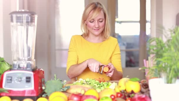 Woman peeling carrot — Stock Video