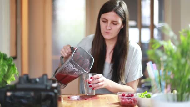 Woman pouring smoothie into glass — Stock Video