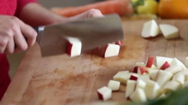 woman cutting apple with knife
