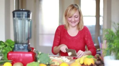Blonde woman chopping apple