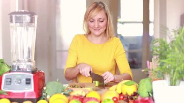 Girl slicing kiwi for smoothie