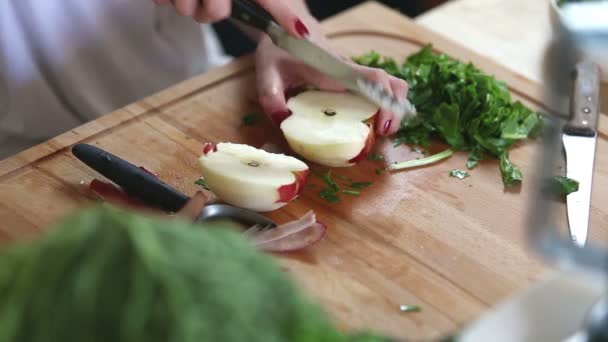 Woman cutting apple on slices — Stockvideo