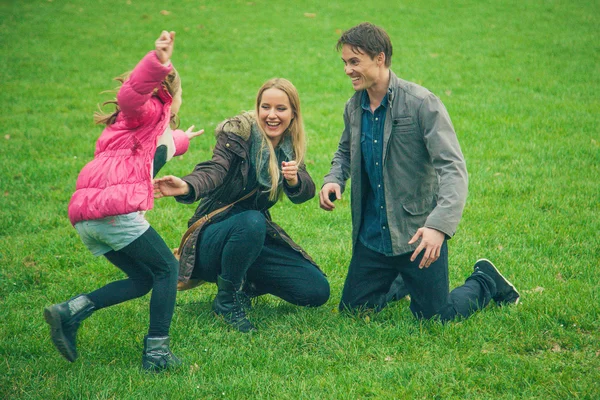 Família brincando no parque — Fotografia de Stock