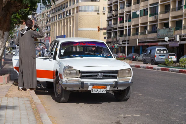 Pessoas que entram no táxi antigo — Fotografia de Stock