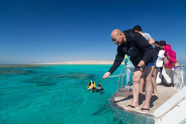 Tourist hand fishing from the boat — Stock Photo, Image