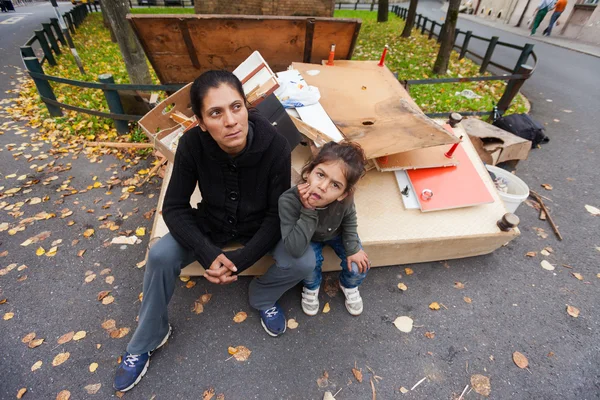 Mother and daughter sitting at the garbage dump — Stock Photo, Image