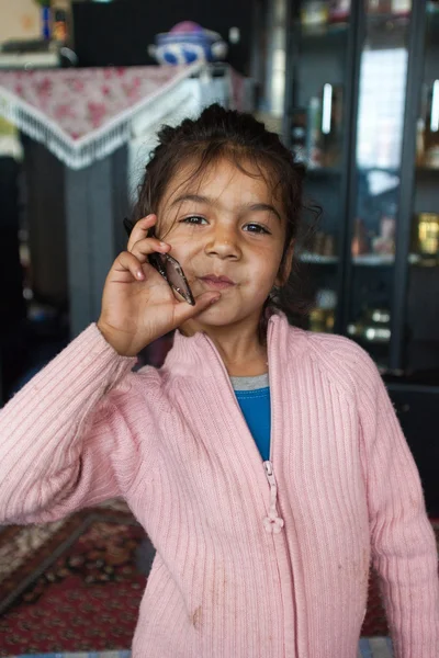 Roma girl holding mobile phone — Stock Photo, Image