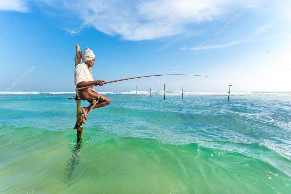 Elderly stilt fisherman at Hikkaduwa Beach. — Stock Editorial Photo ©  paulprescott #54767381