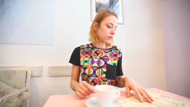 Frau trinkt Kaffee in einem Café — Stockvideo