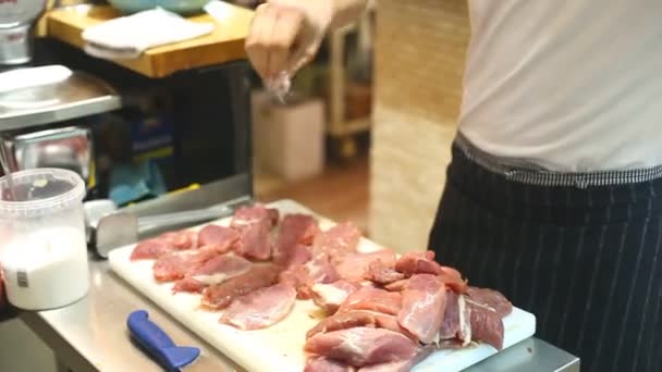 Chef seasoning raw meat — Stock Video